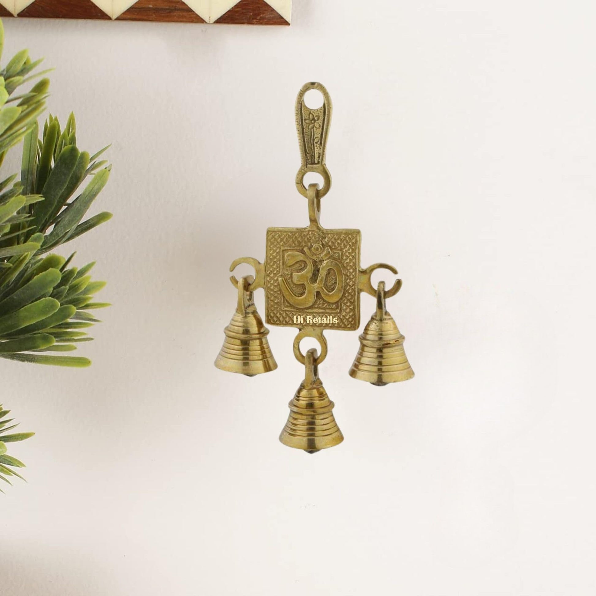 Traditional brass Om hanging bells for temple door or home decor, enhancing your spiritual space at www.hiretails.com